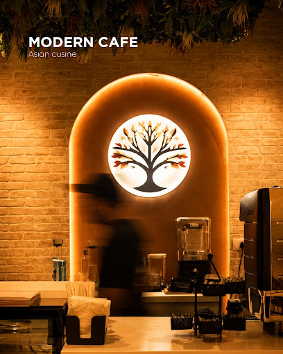 Warm arched backlit tree mural above the counter at Cafe Iroki